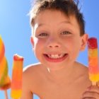 Un niño comiendo un helado en la playa