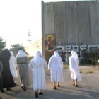 Unas religiosas católicas pasan junto al muro que tiene encajonados a los habitantes de Belén