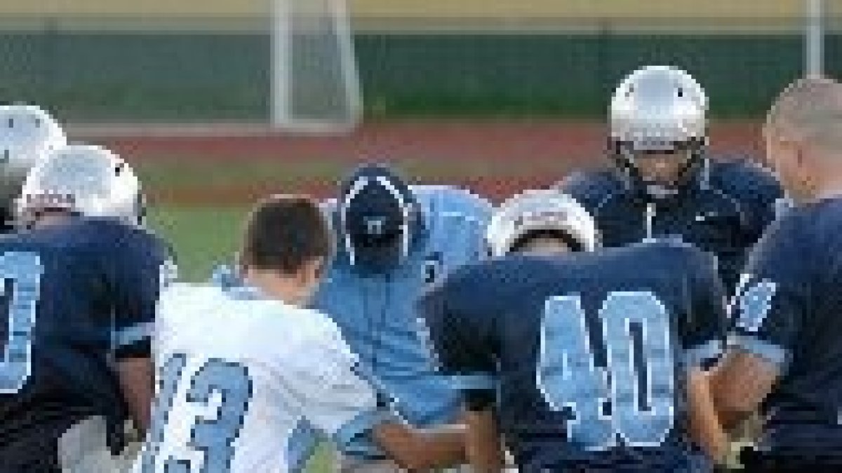 Deportistas católicos rezando