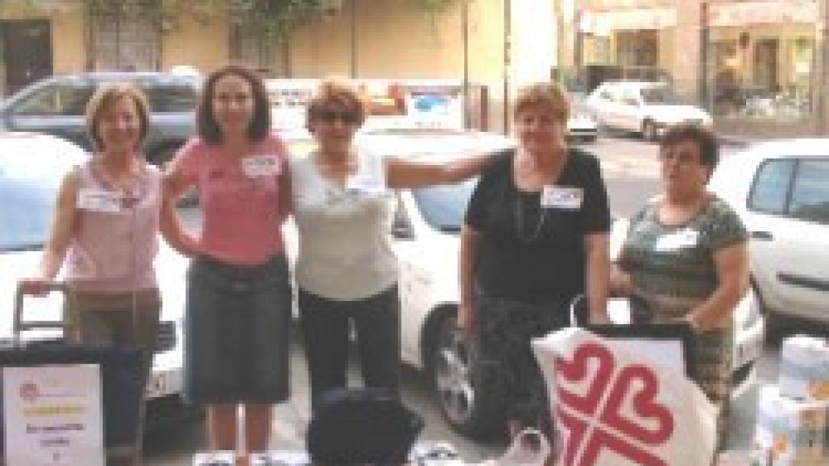 Unas voluntarias de Cáritas en Murcia recogen alimentos - la red en 20.000 parroquias no descansa