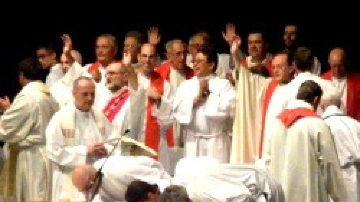 Sacerdotes cantan, alaban y besan el altar en la procesión de entrada de una misa de la Renovación Carismática