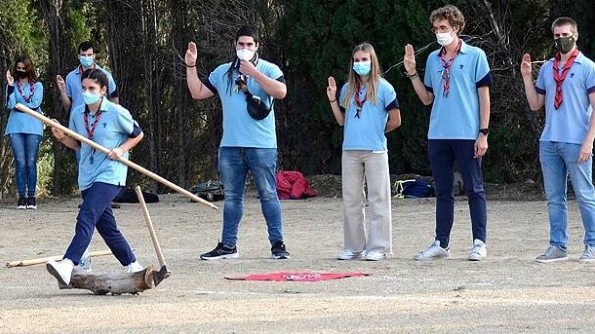 Jóvenes ligados a los marianistas de Zaragoza realizan el saludo scout en una actividad al aire libre