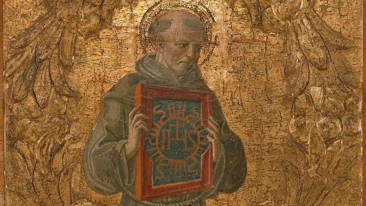 San Bernardino de Siena, mostrando una de las tablas con el símbolo IHS que utilizaba para predicar la devoción al Santísimo Nombre de Jesús. Tabla de Benvenuto di Giovanni (1474), Metropolitan Museum de Nueva York.