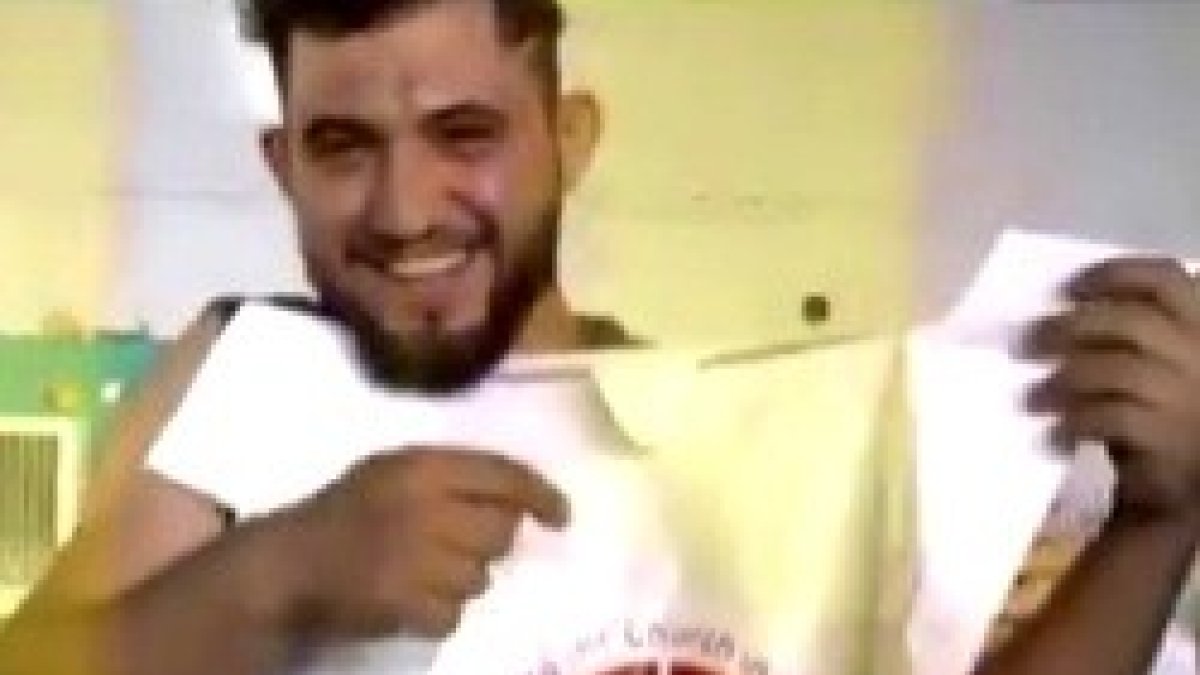 Un joven iraquí con el logo de Ayuda a la Iglesia Necesitada